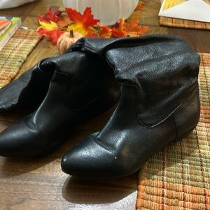 Mid length black boots . Upper leather with man made souls . Size 8 medium.
